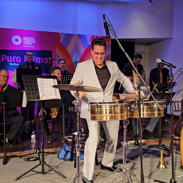 A man plays the timbales with the Mambo Legends Orchestra.
