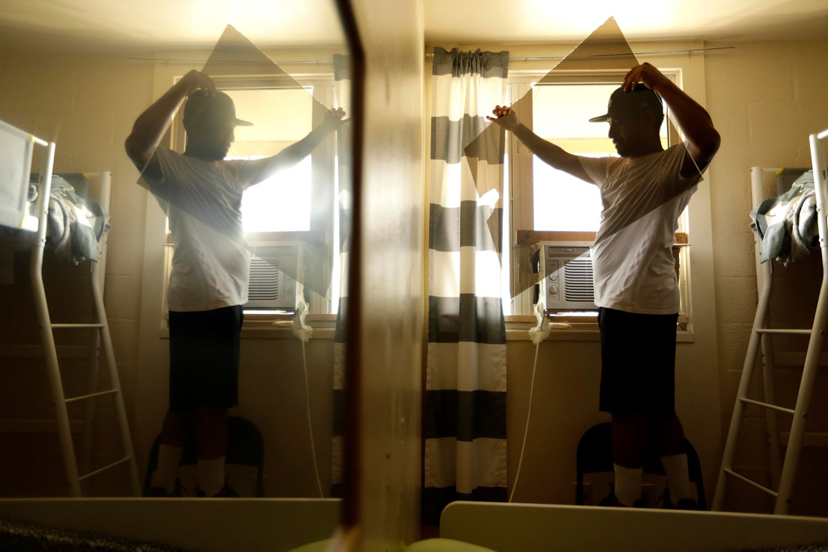Jose Peña installs an AC unit in a family's home where the temperature reached 94 degrees.