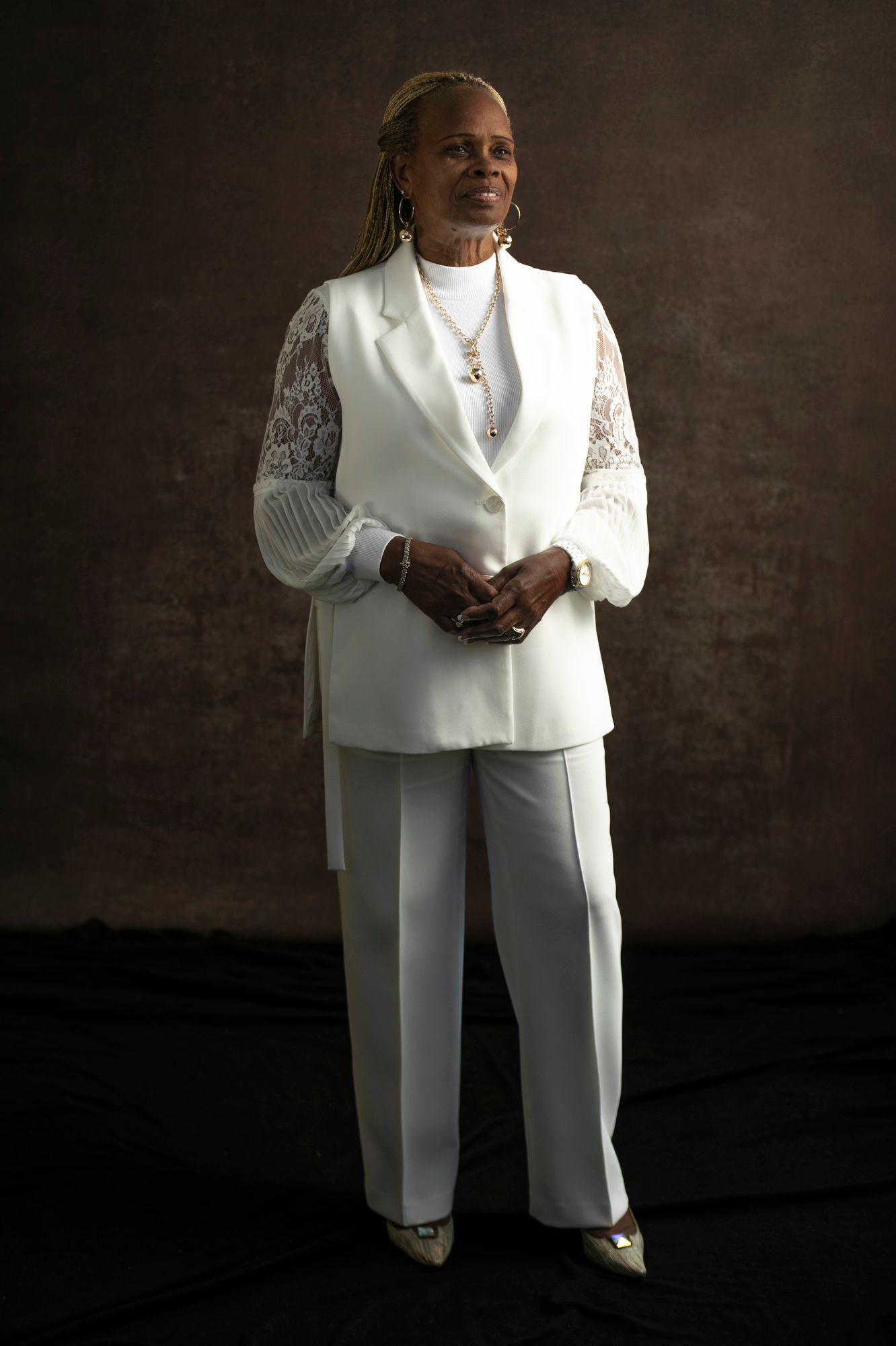 Doris Bursey stands in a white suit with shear sleeves